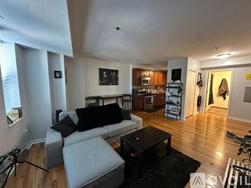 Chicago apartment for rent - A living room with a grey couch and a black coffee table.