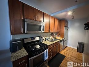 Chicago apartment for rent - A kitchen with wooden cabinets and a granite countertop.