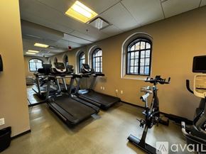 Chicago apartment for rent - A gym with treadmills, elliptical machines, and a television.