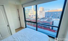 Los Angeles condo for rent - A bedroom with a large bed and a view of the city.