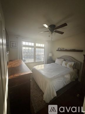 Boston condo for rent - A bedroom with a bed, dresser, and window.