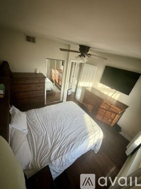 Boston condo for rent - A bedroom with a bed, dresser, and a ceiling fan.