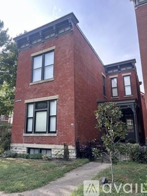 Newport house for rent - A red brick house with a tree in front.