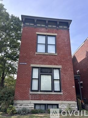Newport house for rent - A red brick building with a black window and a sign that says "AVAIL".