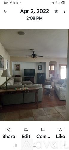 Phoenix house for rent - A living room with a television, couch, and a ceiling fan.