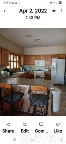 Phoenix house for rent - A kitchen with wooden cabinets and a white refrigerator.