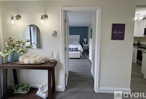 Laconia condo for rent - A room with a table and a mirror on the wall.