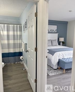 Laconia condo for rent - A bedroom with a bed and a toilet.