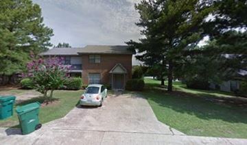 Tupelo apartment for rent - A car is parked in a driveway in front of a house.