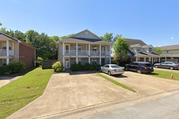 Tupelo apartment for rent - A sunny day at a residential area with houses and cars.