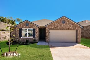 Oklahoma City house for rent - A brick house with a garage door is for sale.