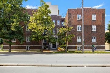 Ottawa apartment for rent - A red brick building with trees in front.