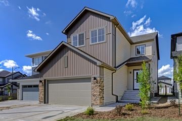 Edmonton apartment for rent - A modern house with a garage door and a stone wall.
