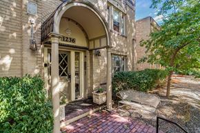 Denver apartment for rent - A building with the number 1236 on it has a doorway with a bench outside.