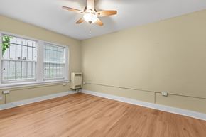 Denver apartment for rent - A room with a ceiling fan and a window with blinds.