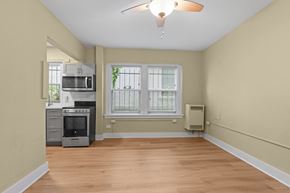 Denver apartment for rent - A kitchen with a microwave, oven, and a window.