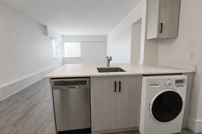 Vancouver apartment for rent - A modern kitchen with a washer and dryer built into the cabinetry.