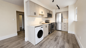 Vancouver apartment for rent - A kitchen with a washing machine built into the cabinetry.