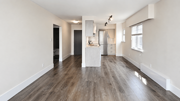 Vancouver apartment for rent - A spacious kitchen with a refrigerator, sink, and cabinets is visible.