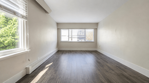 Vancouver apartment for rent - A room with wooden floors and a window letting in natural light.