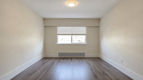 Vancouver apartment for rent - A room with a window and wooden flooring.