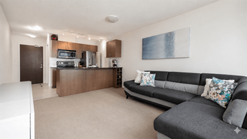 Vancouver apartment for rent - A living room with a grey couch and a painting on the wall.