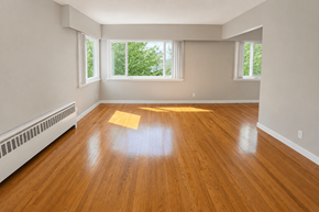 Vancouver apartment for rent - A room with wooden floors and white walls.
