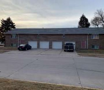 Gibbon apartment for rent - A building with a parking lot in front of it.