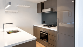 Vanvcouver apartment for rent - A modern kitchen with a white countertop and stainless steel appliances.