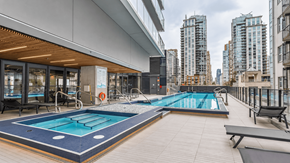 Vanvcouver apartment for rent - A swimming pool on a rooftop with a cityscape in the background.
