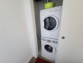 Vancouver apartment for rent - A white washing machine is in a small room.