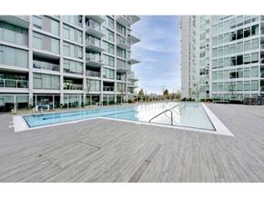 Vancouver apartment for rent - A large wooden deck with a pool in the middle of it.
