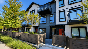 Tsawwassen apartment for rent - A modern apartment building with balconies and a red door.