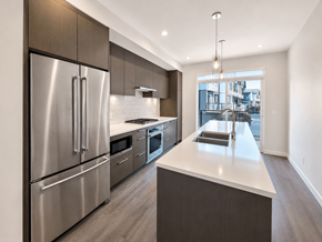 Tsawwassen apartment for rent - A modern kitchen with stainless steel appliances and a large island.