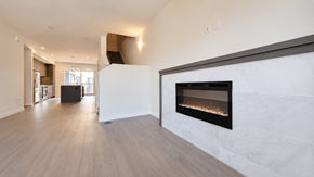 Tsawwassen apartment for rent - A modern living room with a fireplace and hardwood floors.