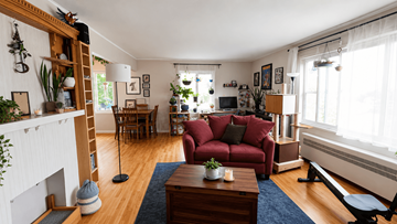 Vancouver apartment for rent - A living room with a red couch and a fireplace.
