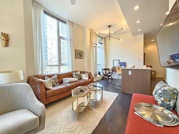 Vancouver apartment for rent - A living room with a brown couch and a coffee table.