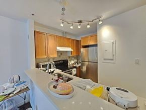 Vancouver apartment for rent - A kitchen with a counter and a fridge.
