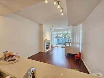 Vancouver apartment for rent - A kitchen with a table and chairs in front of a window.
