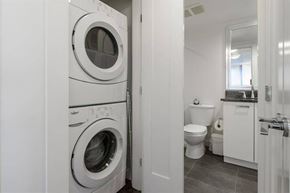 Vancouver apartment for rent - A white washing machine and dryer in a small laundry room.