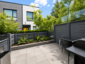 Burnaby apartment for rent - A modern house with a grey exterior and a small garden area.