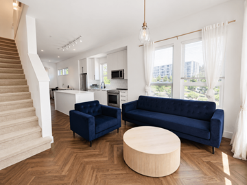 Burnaby apartment for rent - A living room with a blue couch and a wooden coffee table.