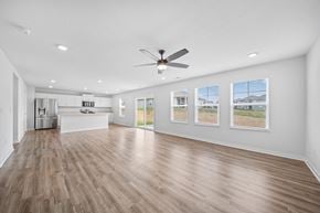 Lithopolis house for rent - A spacious room with a ceiling fan and wooden flooring.