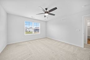 Lithopolis house for rent - A room with a ceiling fan and a window showing a view of buildings and trees.