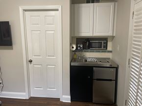 Atlanta apartment for rent - A white door is on the left and a black fridge is on the right.