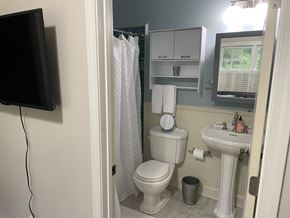 Atlanta apartment for rent - A bathroom with a toilet, sink, and a mirror.