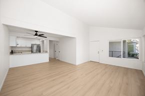West Covina apartment for rent - A spacious room with wooden flooring and a ceiling fan.