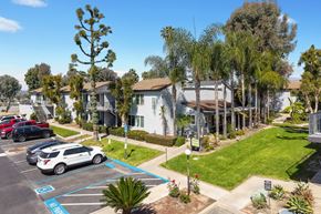 West Covina apartment for rent - A parking lot with a car parked in a handicap spot.