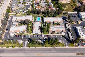 West Covina apartment for rent - A parking lot with cars and a building in the background.