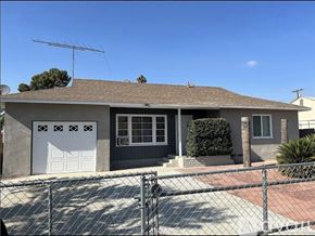 Hemet apartment for rent - A house with a grey roof and a white garage door.